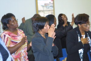 People praying together in a room.